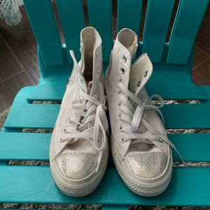 White high top converse with silver toe and heel